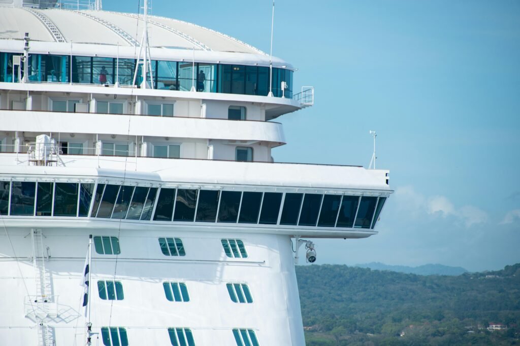 A detailed view of a cruise ship with clear skies, highlighting its design and architecture.