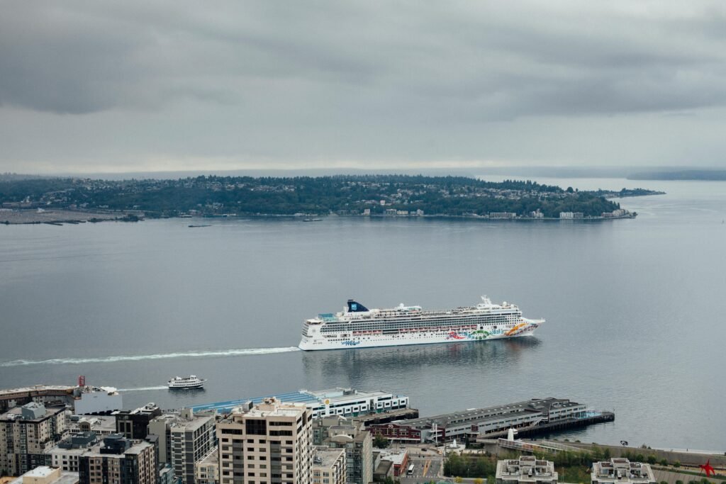 Aerial view of a cruise ship leaving city harbor, ideal for travel promotions.